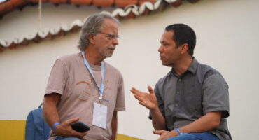 Mia Couto e Itamar Vieira Junior conversam em momento de descontração_ dupla de autores promoveu o debate Conversa para desentortar arados (Foto: Ranch Films)